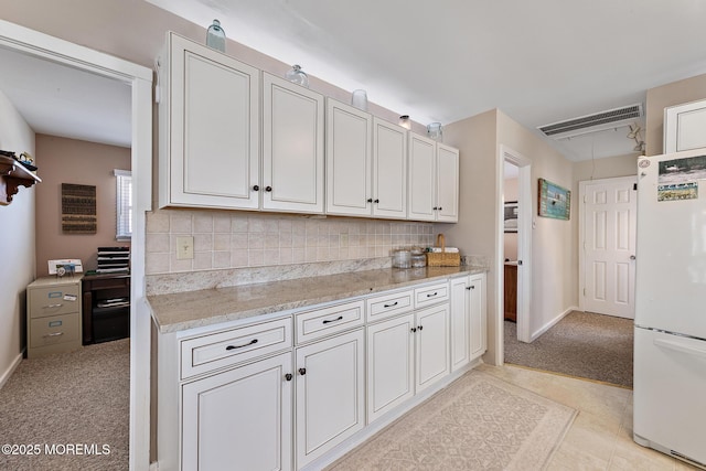 118 S Binnacle Dr, Little Egg Harbor, NJ 08087 - kitchen with freestanding refrigerator, light carpet, decorative backsplash, light stone countertops, and white cabinetry