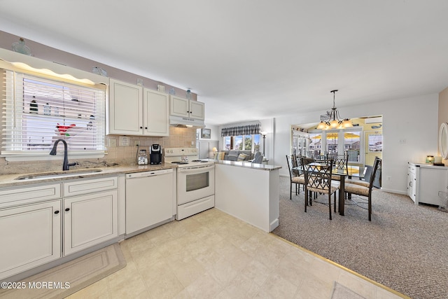 118 S Binnacle Dr, Little Egg Harbor, NJ 08087 - kitchen with white appliances, under cabinet range hood, healthy amount of natural light, and a chandelier