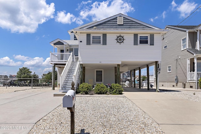 118 S Binnacle Dr, Little Egg Harbor, NJ 08087 - view of front facade featuring a carport, concrete driveway, and stairway