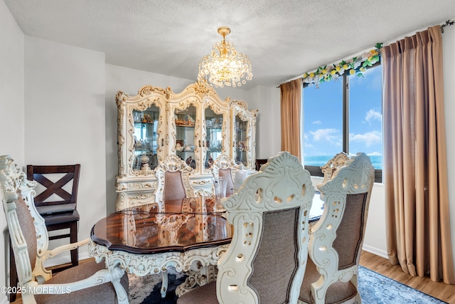 2508 Harmon Cv, Secaucus, NJ 07094 - dining room with a chandelier, a textured ceiling, and wood finished floors