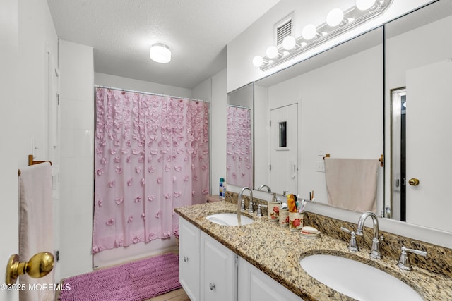 2508 Harmon Cv, Secaucus, NJ 07094 - full bathroom with double vanity and a textured ceiling