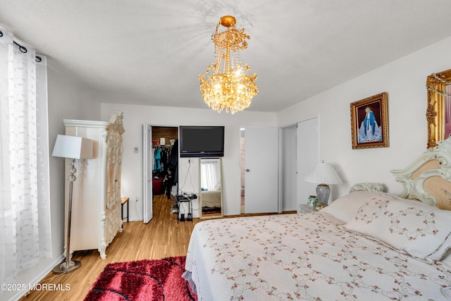 2508 Harmon Cv, Secaucus, NJ 07094 - bedroom featuring light wood-style flooring and a chandelier