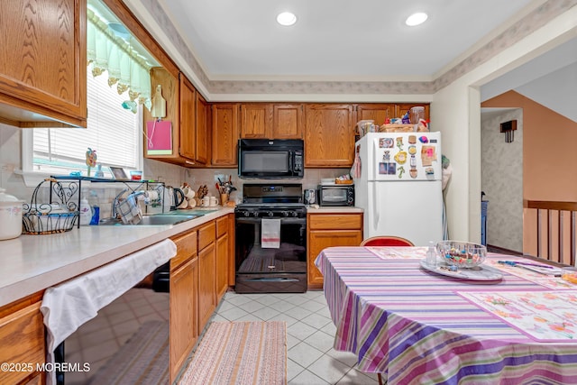 13 Heritage Dr, Howell, NJ 07731 - kitchen featuring black appliances, light countertops, brown cabinets, light tile patterned floors, and tasteful backsplash