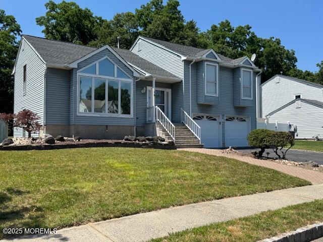 13 Heritage Dr, Howell, NJ 07731 - split level home featuring an attached garage, a front yard, and asphalt driveway