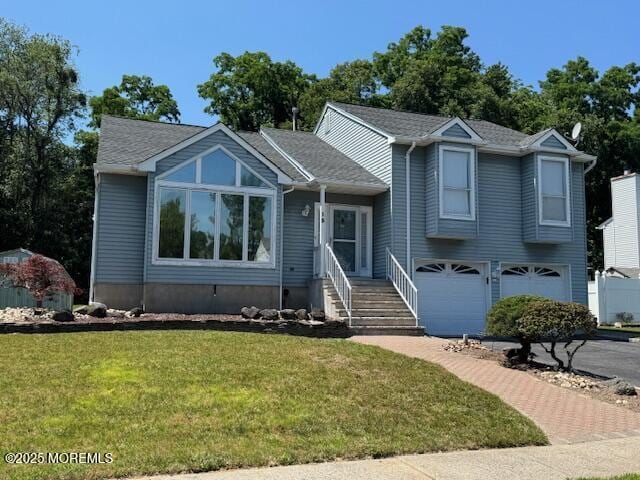 13 Heritage Dr, Howell, NJ 07731 - tri-level home with a front lawn and a garage