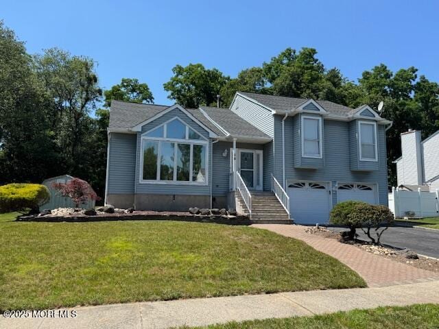 13 Heritage Dr, Howell, NJ 07731 - split level home featuring a garage, a front yard, and asphalt driveway