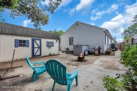 1506 Beverly Rd, Forked River, NJ 08731 - back of house featuring a fire pit, a patio, and a storage shed