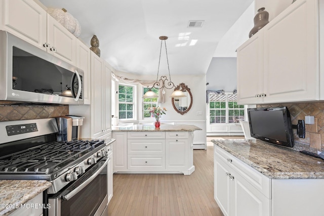 96 Kentucky Way, Freehold, NJ 07728 - kitchen featuring stainless steel appliances, light wood-style floors, white cabinets, backsplash, and light stone counters