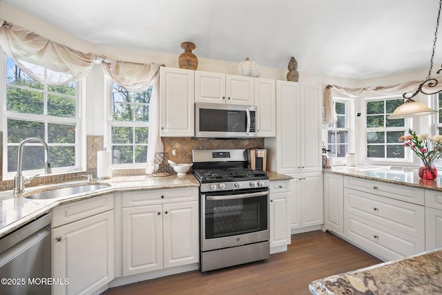 96 Kentucky Way, Freehold, NJ 07728 - kitchen featuring appliances with stainless steel finishes, white cabinets, hardwood / wood-style floors, backsplash, and light stone counters