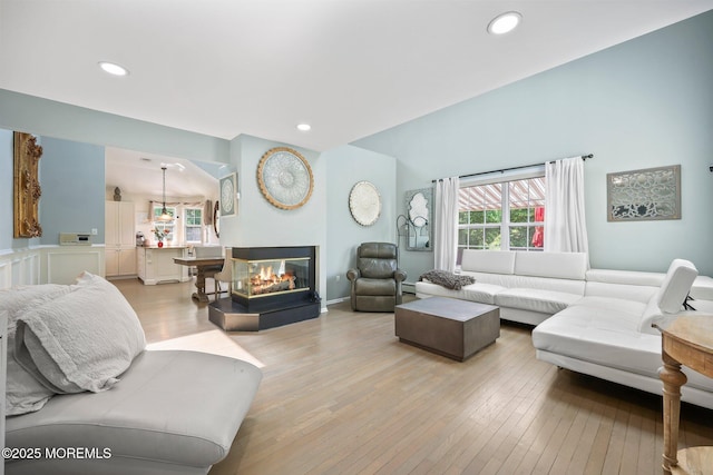 96 Kentucky Way, Freehold, NJ 07728 - living room with healthy amount of natural light, light wood finished floors, recessed lighting, and a multi sided fireplace