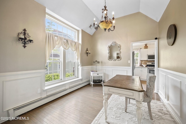 96 Kentucky Way, Freehold, NJ 07728 - dining area with wainscoting, a chandelier, a baseboard heating unit, a decorative wall, and hardwood / wood-style flooring