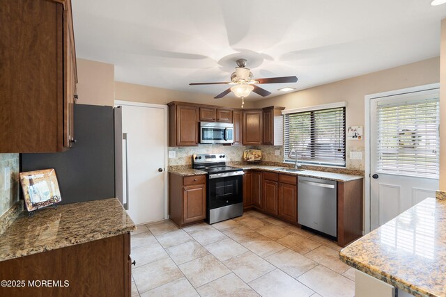603-B Bosworth Ct, Manchester, NJ 08759 - kitchen featuring stainless steel appliances, tasteful backsplash, a ceiling fan, light stone countertops, and light tile patterned floors
