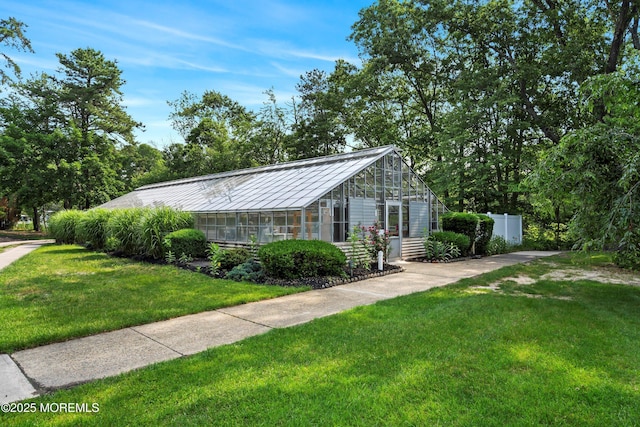 603-B Bosworth Ct, Manchester, NJ 08759 - view of front of house featuring a greenhouse, a standing seam roof, a metal roof, and an outbuilding