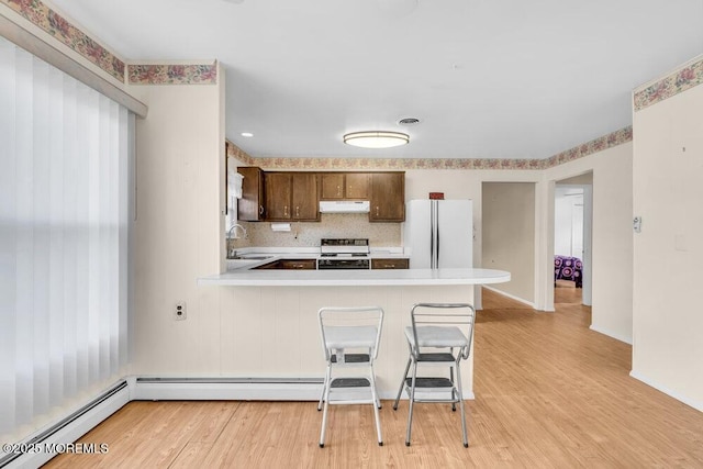 68 Barbados Dr S, Toms River, NJ 08757 - kitchen with white appliances, under cabinet range hood, light countertops, and light wood finished floors