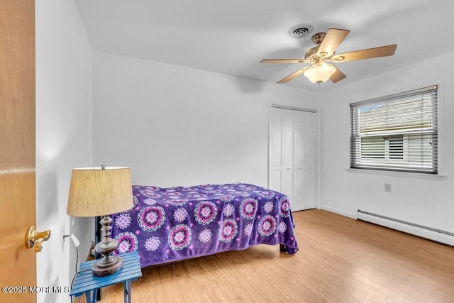 68 Barbados Dr S, Toms River, NJ 08757 - bedroom with wood finished floors, a closet, a baseboard radiator, and ceiling fan