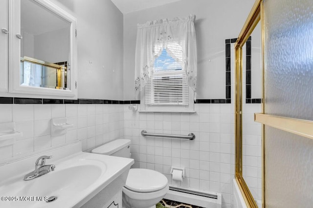 68 Barbados Dr S, Toms River, NJ 08757 - bathroom with a baseboard heating unit, vanity, tile walls, combined bath / shower with glass door, and a wainscoted wall