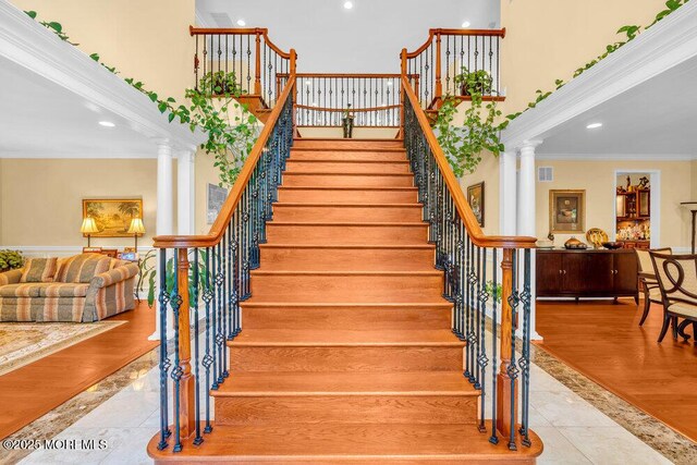 312 Clearstream Rd, Jackson, NJ 08527 - staircase featuring a high ceiling, ornamental molding, ornate columns, tile patterned flooring, and recessed lighting