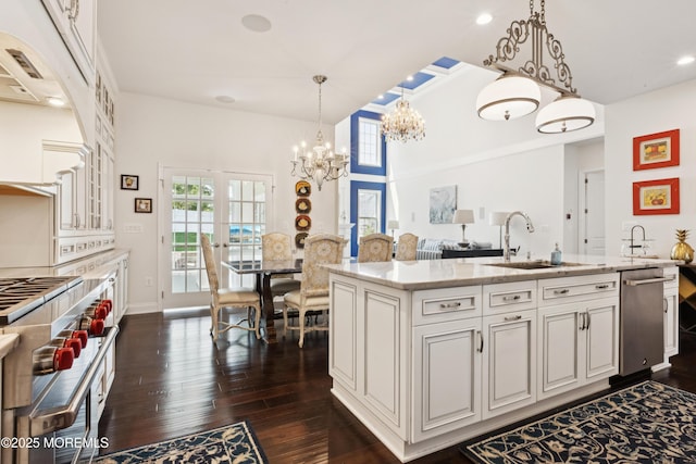 23 Interlachen Ct, Monroe, NJ 08831 - kitchen with stainless steel appliances, a chandelier, dark wood-style floors, light stone countertops, and decorative light fixtures