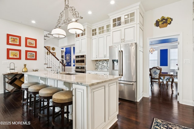 23 Interlachen Ct, Monroe, NJ 08831 - kitchen featuring appliances with stainless steel finishes, dark wood finished floors, a chandelier, light stone countertops, and white cabinets