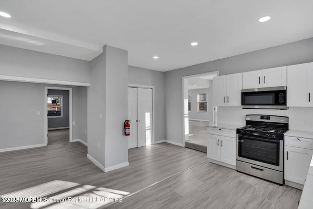 58 Chadwick Ave, Toms River, NJ 08753 - kitchen featuring appliances with stainless steel finishes, white cabinetry, recessed lighting, light wood-style floors, and light countertops