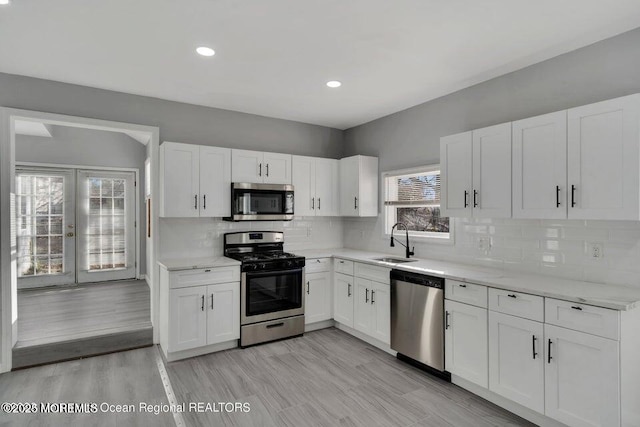 58 Chadwick Ave, Toms River, NJ 08753 - kitchen featuring appliances with stainless steel finishes, white cabinets, french doors, light stone counters, and recessed lighting
