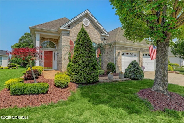 86 Wild Dunes Way, Jackson, NJ 08527 - view of front facade with a front lawn, driveway, brick siding, an attached garage, and roof with shingles