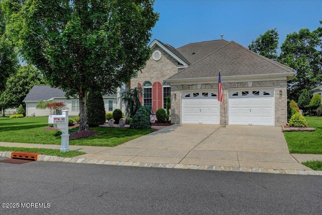 86 Wild Dunes Way, Jackson, NJ 08527 - traditional-style house featuring a garage, a front lawn, driveway, brick siding, and roof with shingles