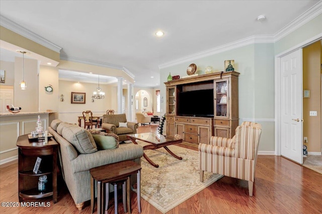 86 Wild Dunes Way, Jackson, NJ 08527 - living room with wood finished floors, arched walkways, recessed lighting, crown molding, and a chandelier
