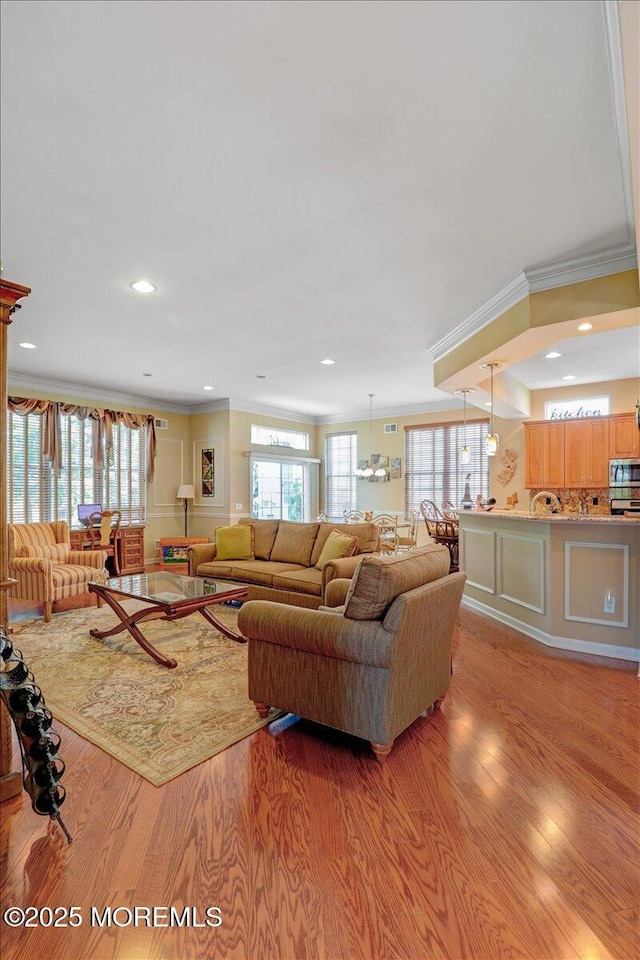 86 Wild Dunes Way, Jackson, NJ 08527 - living area with crown molding, light wood-type flooring, plenty of natural light, and recessed lighting