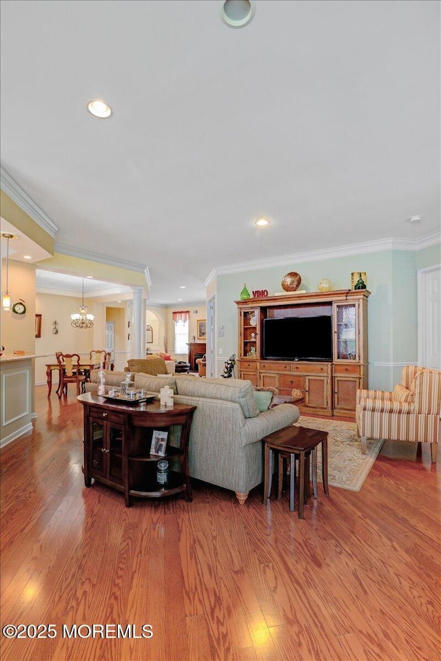 86 Wild Dunes Way, Jackson, NJ 08527 - living room featuring crown molding, wood finished floors, a chandelier, ornate columns, and recessed lighting