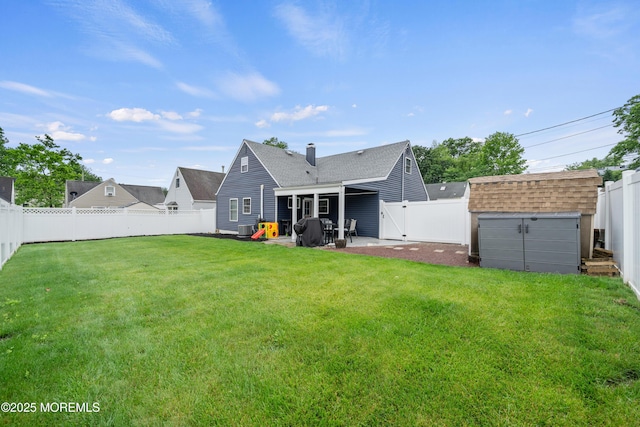 6 Linda Ave, Colonia, NJ 07067 - rear view of property with a fenced backyard, a shingled roof, a patio, a storage unit, and a gate