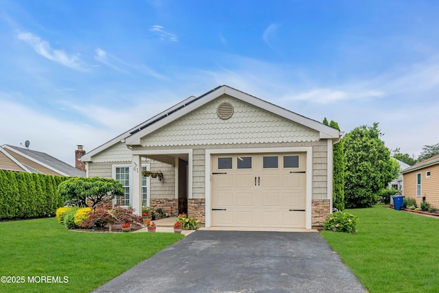 61 Mansfield Ave, Manchester, NJ 08759 - view of front of home with stone siding, a front yard, and driveway