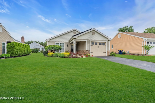 61 Mansfield Ave, Manchester, NJ 08759 - view of front of home with asphalt driveway, a front lawn, a garage, and stone siding