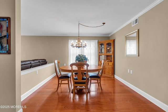 61 Mansfield Ave, Manchester, NJ 08759 - dining space featuring plenty of natural light, a chandelier, ornamental molding, and wood finished floors