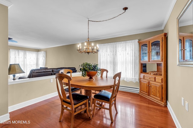 61 Mansfield Ave, Manchester, NJ 08759 - dining space featuring wood finished floors, ornamental molding, a baseboard radiator, and a chandelier