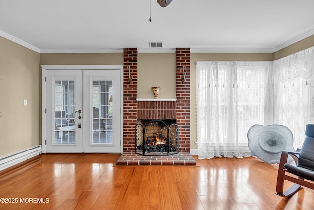 61 Mansfield Ave, Manchester, NJ 08759 - living area with wood finished floors, crown molding, french doors, baseboard heating, and a brick fireplace