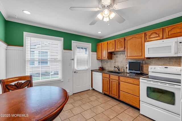 61 Mansfield Ave, Manchester, NJ 08759 - kitchen with white appliances, light tile patterned flooring, a ceiling fan, backsplash, and wainscoting