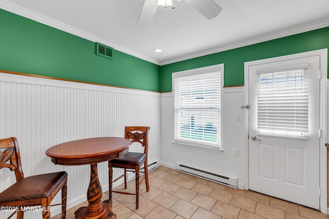 61 Mansfield Ave, Manchester, NJ 08759 - dining area with baseboard heating, a ceiling fan, a wainscoted wall, crown molding, and light tile patterned floors