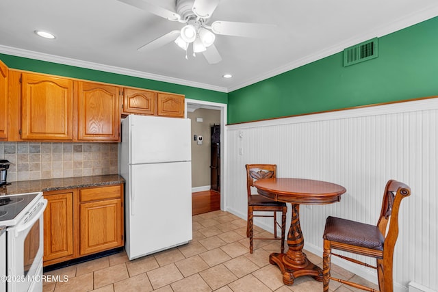 61 Mansfield Ave, Manchester, NJ 08759 - kitchen with white appliances, decorative backsplash, ceiling fan, dark countertops, and light tile patterned floors