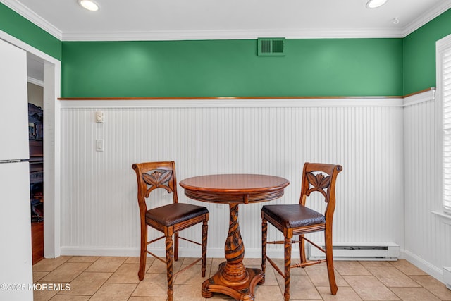 61 Mansfield Ave, Manchester, NJ 08759 - dining area featuring a baseboard heating unit, wainscoting, tile patterned floors, ornamental molding, and healthy amount of natural light