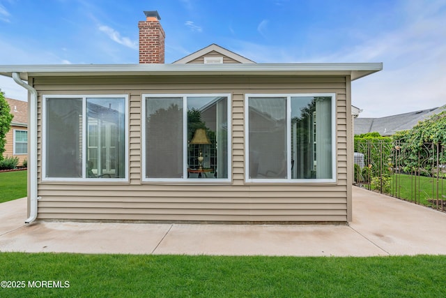 61 Mansfield Ave, Manchester, NJ 08759 - view of side of home with a patio and a chimney