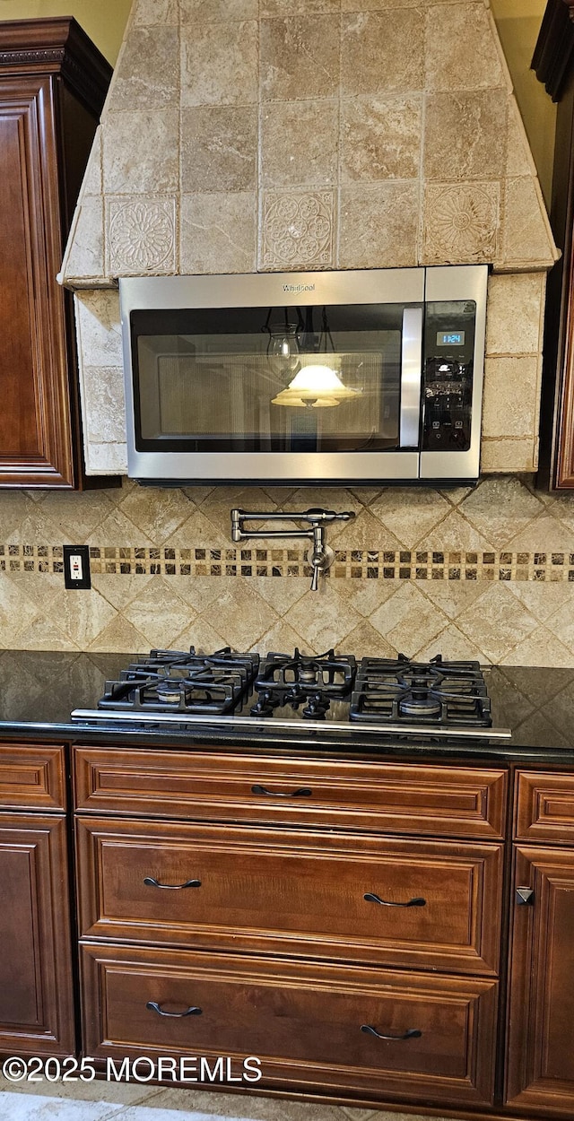 7 Quaker Hill Rd, Jackson, NJ 08527 - kitchen featuring stainless steel microwave, dark countertops, decorative backsplash, and black gas stovetop