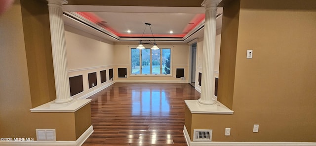 7 Quaker Hill Rd, Jackson, NJ 08527 - unfurnished living room with ornate columns, dark wood-type flooring, a raised ceiling, a decorative wall, and recessed lighting