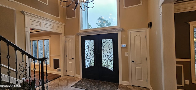 7 Quaker Hill Rd, Jackson, NJ 08527 - foyer entrance featuring a high ceiling, stairs, a chandelier, stone tile flooring, and french doors