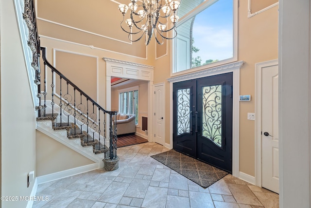 7 Quaker Hill Rd, Jackson, NJ 08527 - entryway with stone tile flooring, a high ceiling, stairway, a chandelier, and french doors