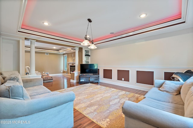 7 Quaker Hill Rd, Jackson, NJ 08527 - living room featuring decorative columns, a tray ceiling, crown molding, recessed lighting, and wood finished floors