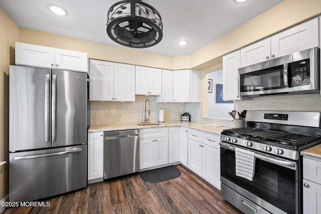 11 Interlaken Ct Unit 9, Freehold, NJ 07728 - kitchen featuring stainless steel appliances, white cabinetry, recessed lighting, light stone counters, and dark wood finished floors