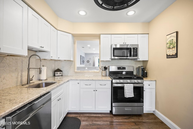 11 Interlaken Ct Unit 9, Freehold, NJ 07728 - kitchen featuring appliances with stainless steel finishes, white cabinets, tasteful backsplash, dark wood-style floors, and recessed lighting