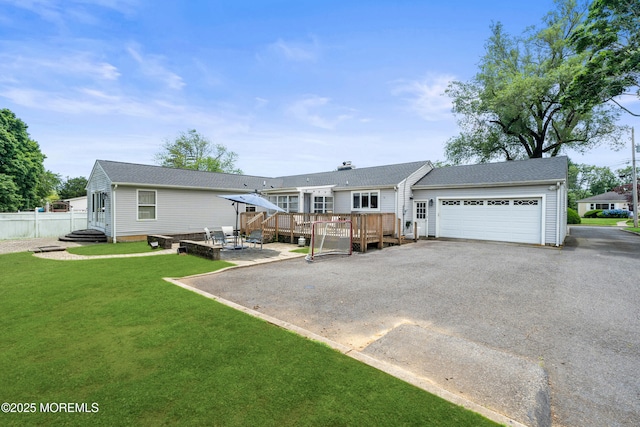 367 Kirby Ave, Long Branch, NJ 07740 - rear view of house with a wooden deck, an attached garage, and asphalt driveway
