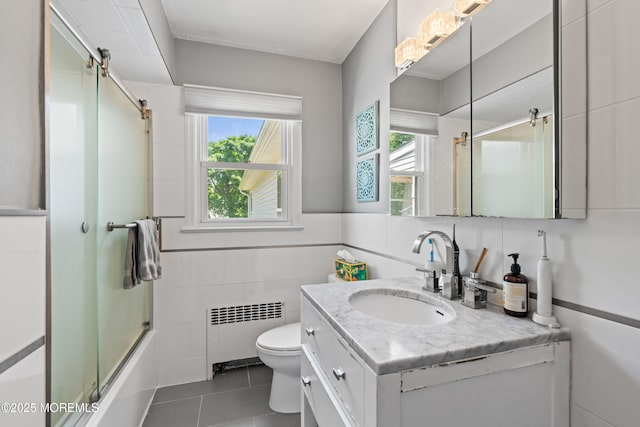367 Kirby Ave, Long Branch, NJ 07740 - full bath with radiator, healthy amount of natural light, tile patterned floors, tile walls, and vanity